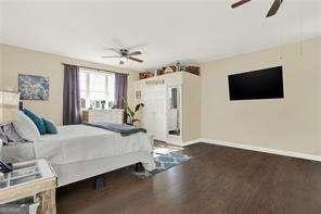 bedroom featuring dark wood-type flooring and ceiling fan