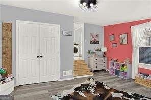 bedroom with hardwood / wood-style flooring and a closet