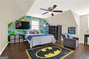 bedroom with dark wood-type flooring, ceiling fan, and vaulted ceiling