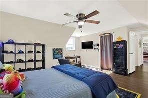 bedroom featuring wood-type flooring and vaulted ceiling