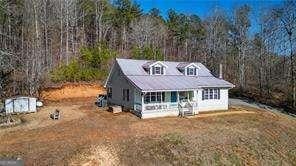 cape cod home with a front yard