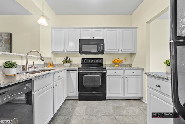 kitchen featuring sink, black appliances, and white cabinets