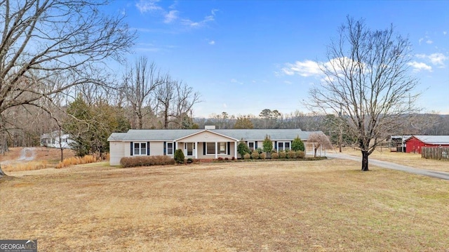 ranch-style house featuring a porch and a front yard