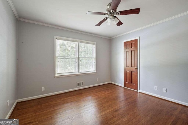 empty room with crown molding, dark wood-type flooring, and ceiling fan