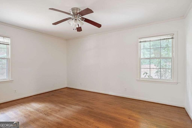 spare room featuring ornamental molding, wood-type flooring, and ceiling fan