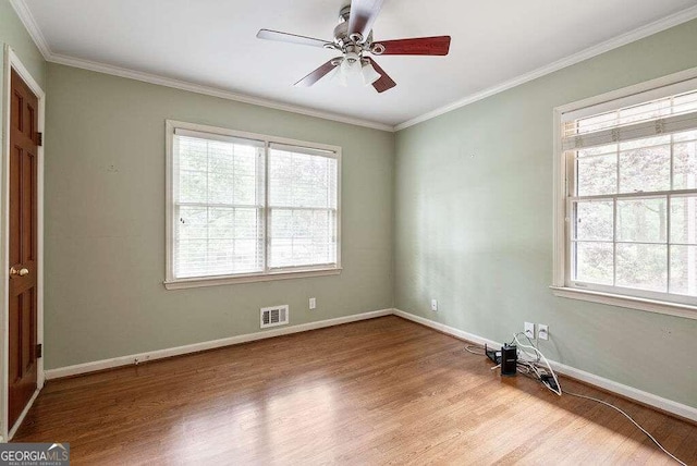 empty room featuring light hardwood / wood-style flooring, ornamental molding, and ceiling fan