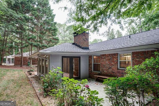 rear view of property with french doors