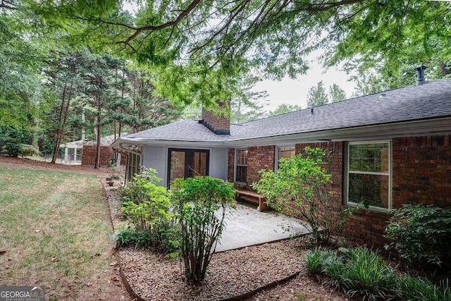 rear view of house featuring a lawn