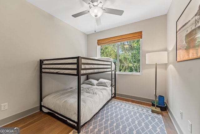 bedroom with wood-type flooring and ceiling fan