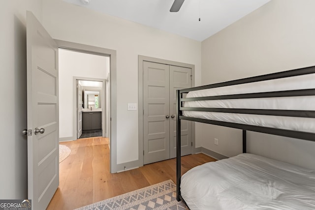 bedroom featuring hardwood / wood-style floors, a closet, and ceiling fan