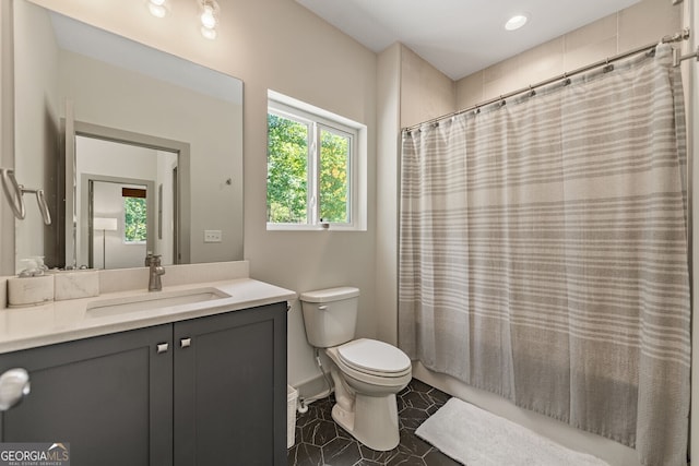 bathroom with vanity, a wealth of natural light, and toilet