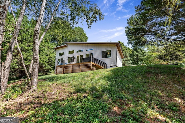 back of property with a wooden deck