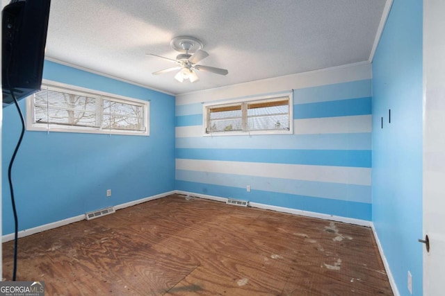 empty room with ceiling fan, crown molding, and a textured ceiling