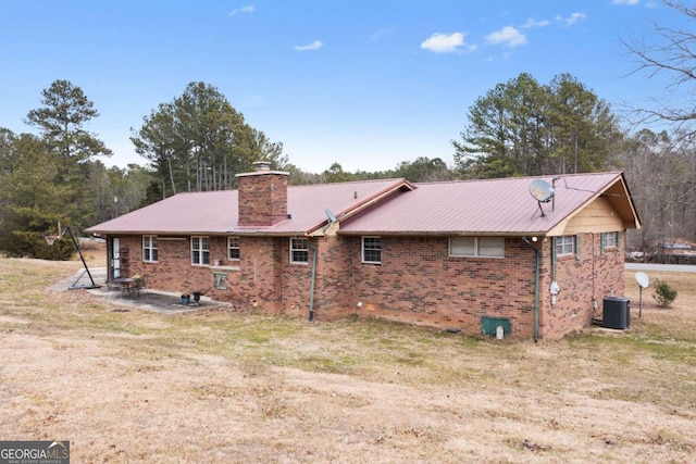 back of house featuring a yard, a patio area, and central air condition unit