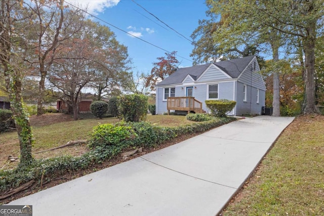 view of front facade with cooling unit, a front yard, and a deck