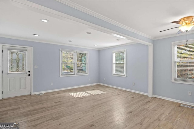 spare room with ornamental molding, ceiling fan, and light wood-type flooring