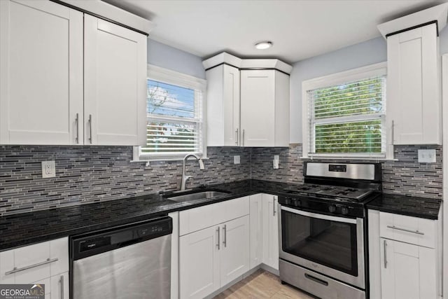 kitchen featuring white cabinetry, stainless steel appliances, sink, and tasteful backsplash