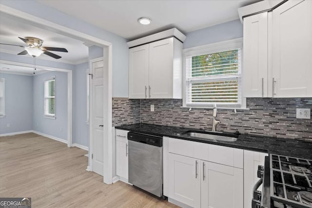 kitchen with gas range, dishwasher, sink, and white cabinets