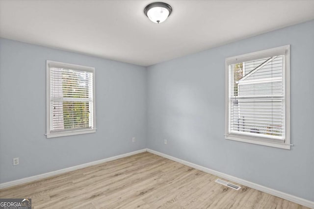 spare room featuring light wood-type flooring