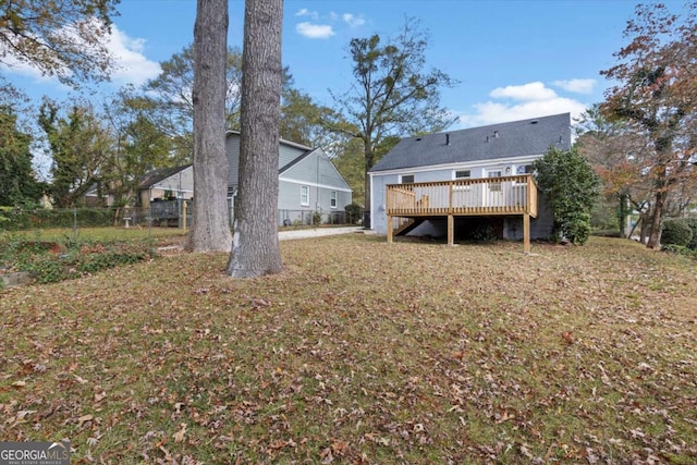 rear view of property with a yard and a deck