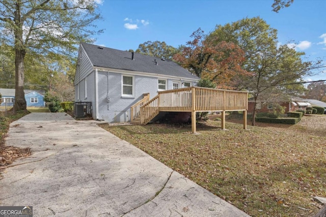 rear view of house featuring central AC and a deck