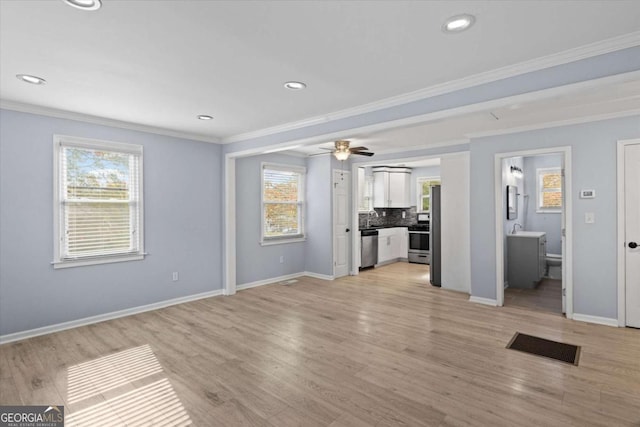 unfurnished living room featuring crown molding, ceiling fan, and light hardwood / wood-style floors