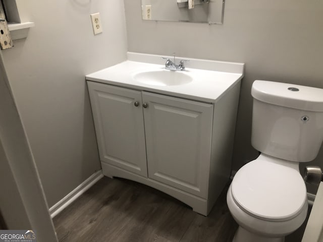 bathroom with vanity, hardwood / wood-style flooring, and toilet