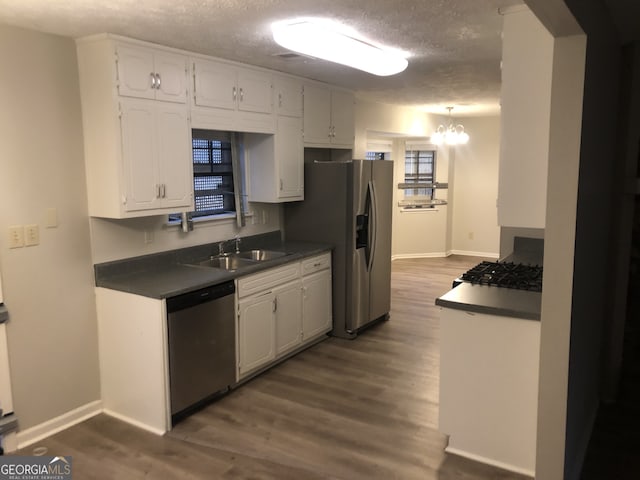 kitchen with white cabinetry, sink, dark hardwood / wood-style floors, and appliances with stainless steel finishes