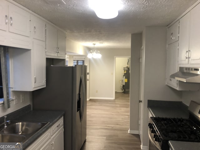 kitchen featuring sink, white cabinetry, a textured ceiling, light hardwood / wood-style flooring, and stainless steel range with gas stovetop