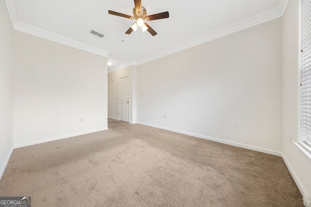 spare room featuring crown molding, ceiling fan, and carpet flooring