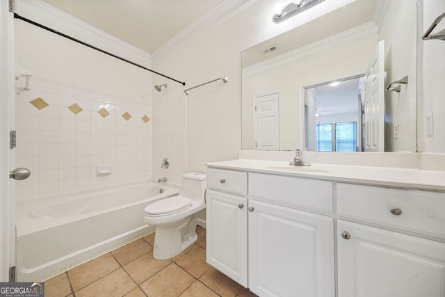 full bathroom featuring crown molding, tile patterned flooring, vanity, tiled shower / bath, and toilet