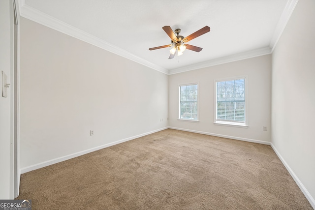 carpeted spare room featuring crown molding and ceiling fan