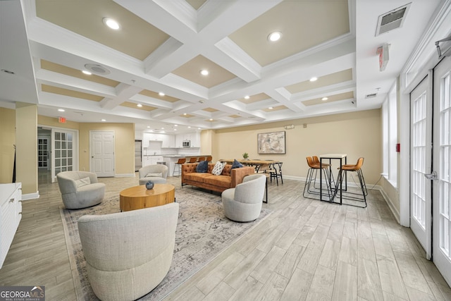 living room with beamed ceiling, coffered ceiling, and light hardwood / wood-style flooring