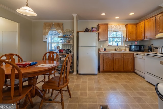 kitchen with pendant lighting, sink, white appliances, and crown molding