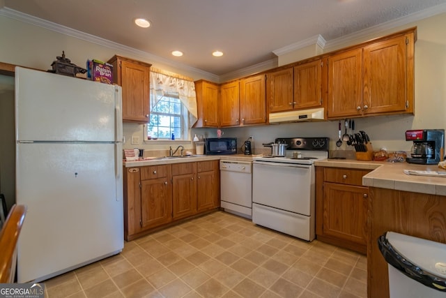 kitchen with crown molding, white appliances, and sink