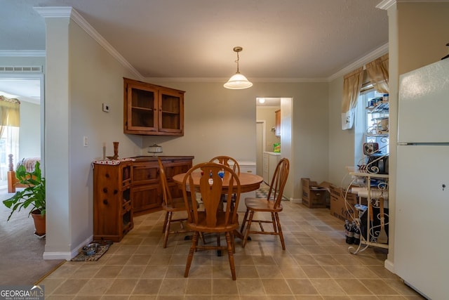 tiled dining area with plenty of natural light and ornamental molding