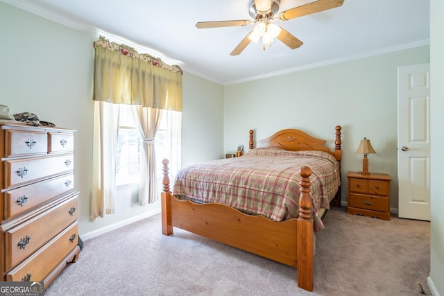 carpeted bedroom with ceiling fan and ornamental molding