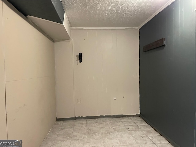 unfurnished room featuring a textured ceiling