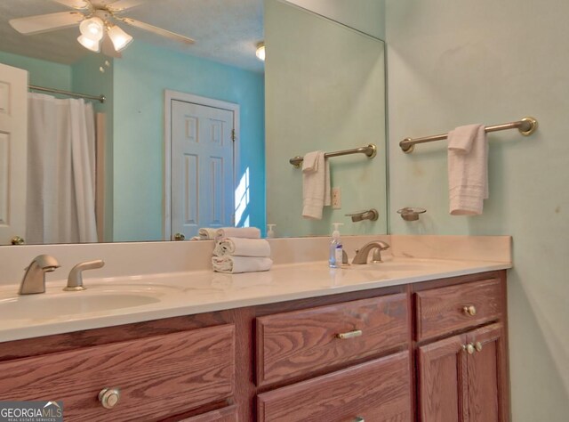 bathroom featuring vanity, ceiling fan, and walk in shower