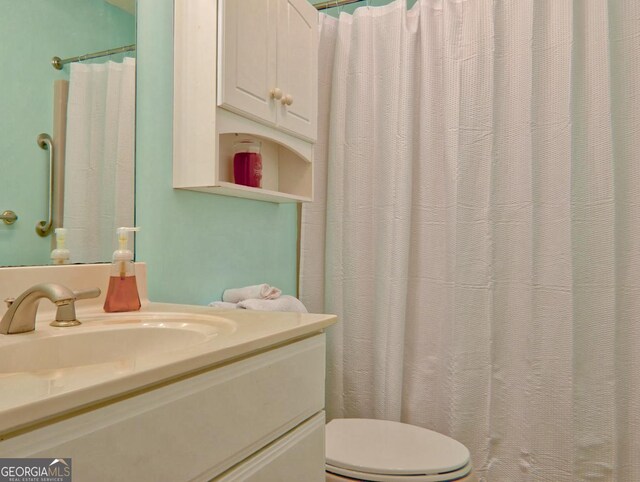 bathroom featuring vanity and toilet