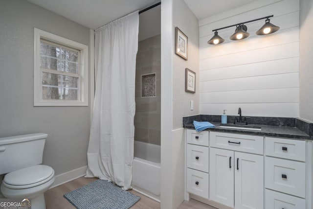 full bathroom featuring vanity, wood-type flooring, toilet, and shower / bathtub combination with curtain