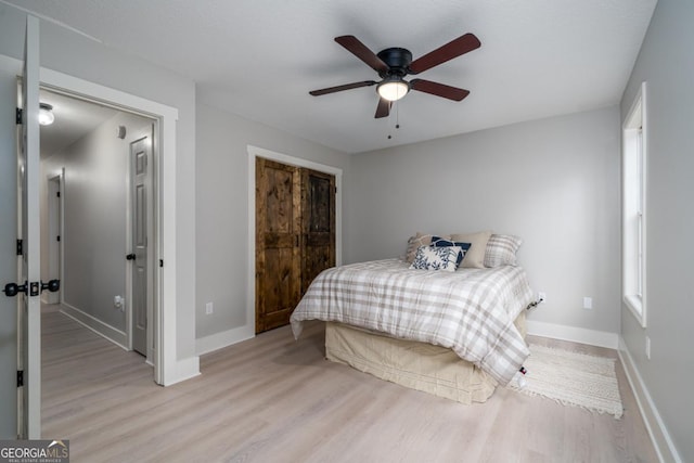 bedroom with light hardwood / wood-style floors and ceiling fan