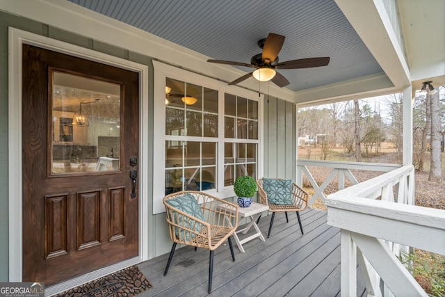 wooden terrace featuring a porch and ceiling fan