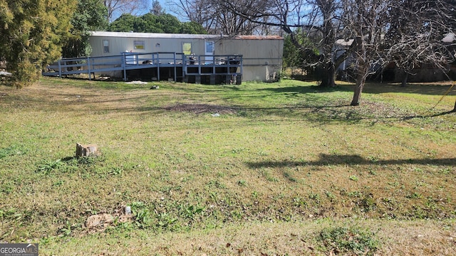 view of yard with a wooden deck