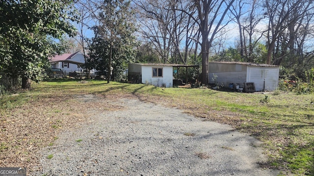 view of front facade with a front yard and a storage shed