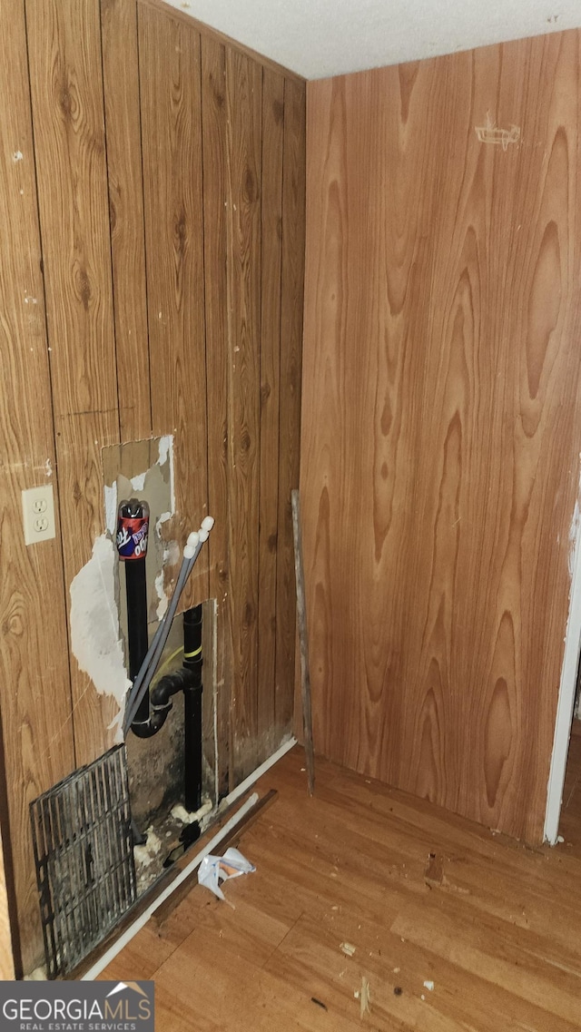 interior space with wooden walls and wood-type flooring