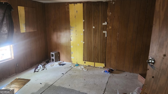 spare room featuring wooden walls