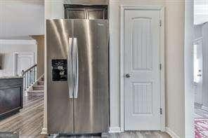 kitchen featuring stainless steel fridge with ice dispenser