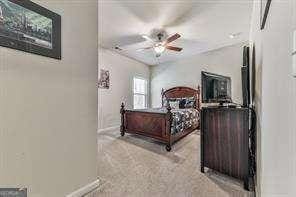 carpeted bedroom with ceiling fan