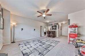 unfurnished living room featuring ceiling fan